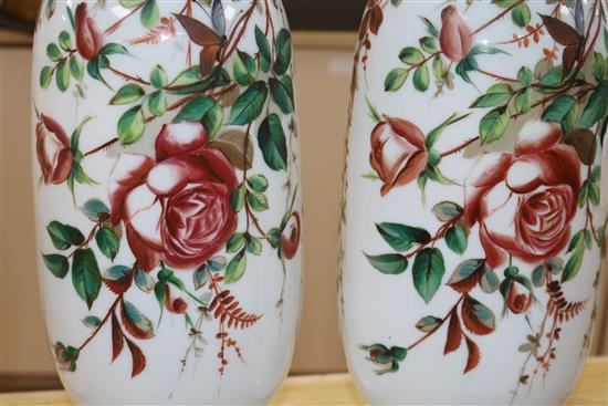 Pair of French 19th century opaline glass tall vases, decorated with rose sprays on a white ground and another pair of opaline vases